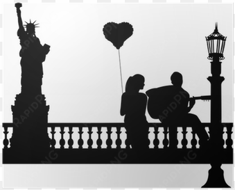 couple in love where a guy plays guitar in new york - statue of liberty silhouette