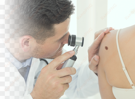doctor checks customer's skin - doctors looking at skin cancer