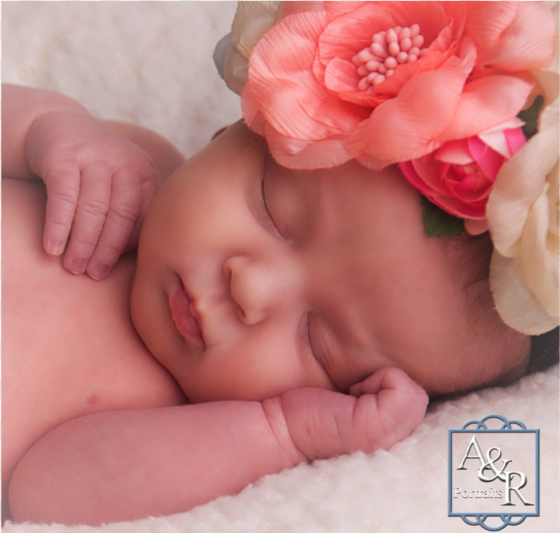 newborn baby asleep with flower crown