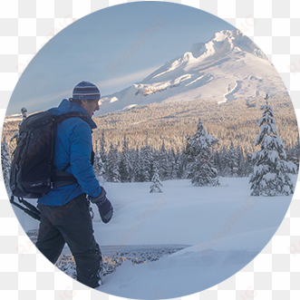 snowshoer with large backpack makes his way across - mount hood