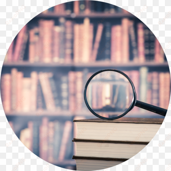 t magnifying glass over books - researching background