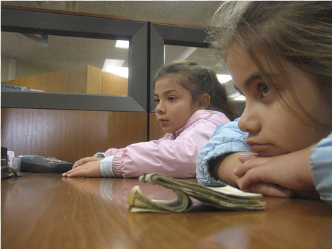 two kids at a bank - girl